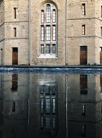 Reflection of building in puddle