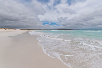 View of beach against cloudy sky