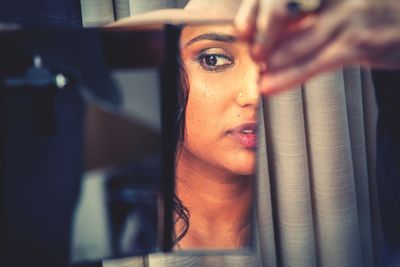 Close-up portrait of young woman reading book