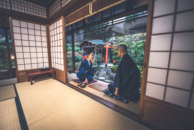 People sitting on table by window