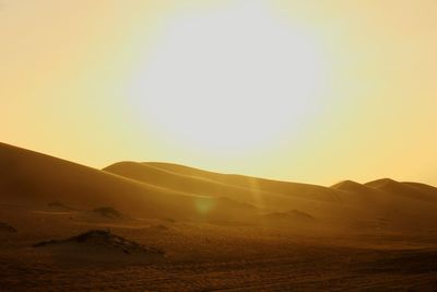 Scenic view of desert against sky during sunset