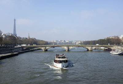 Boats in river with city in background