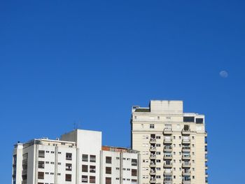 Low angle view of buildings against blue sky