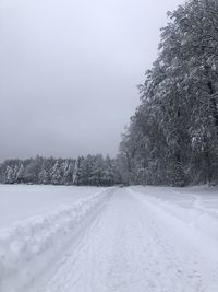 Snow covered field against sky