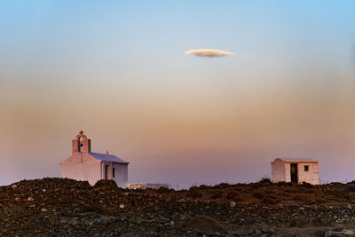 Lighthouse by sea against sky