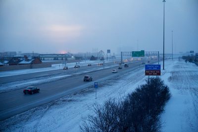 Road passing through snow covered landscape