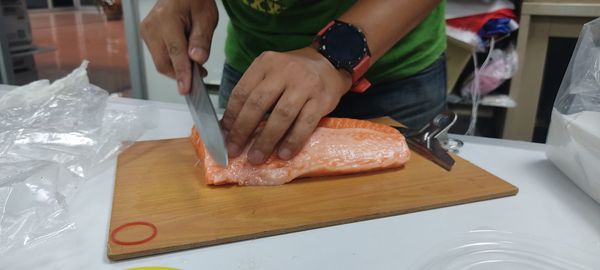 Midsection of man preparing food