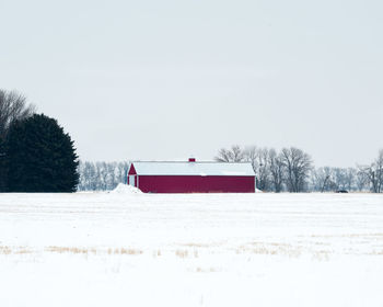 Built structure on snow covered landscape against clear sky