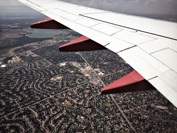 Aerial view of airplane wing over landscape