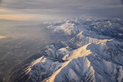 Wasatch front rocky mountain range aerial snow capped peaks winter urban salt lake city utah usa