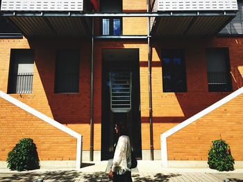 Woman standing against wall