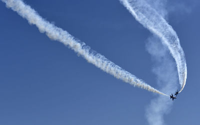 Low angle view of vapor trail against sky