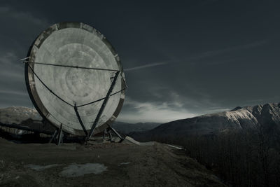 Ferris wheel on mountain against sky