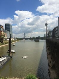 Suspension bridge with cityscape in background