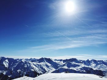 Scenic view of snow covered mountains against sky