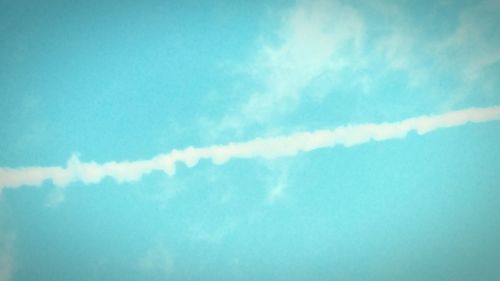 Low angle view of vapor trail in blue sky