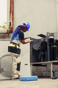 Rear view of man working in workshop