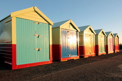 Beach huts on brighton beach at sunset 