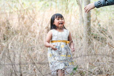 Full length of a girl standing on field