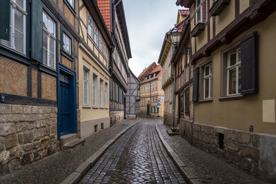 Empty alley amidst buildings in city