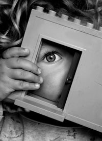 Cute toddler looking through door in toy