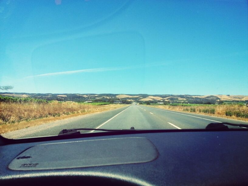 transportation, road, the way forward, mode of transport, windshield, car, road marking, diminishing perspective, country road, land vehicle, vehicle interior, clear sky, landscape, vanishing point, car interior, car point of view, transparent, travel, copy space, glass - material