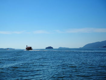 Boat sailing in sea against sky