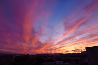 Scenic view of buildings against sky during sunset