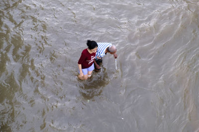 High angle view of boy in sea