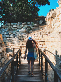 Rear view of woman walking on staircase