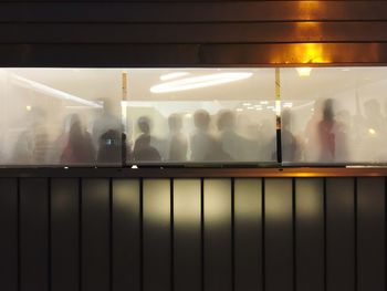 People in illuminated room