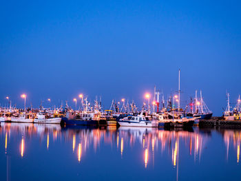 Fishing port at twilight with reflections