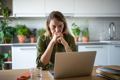 Young woman using laptop at office