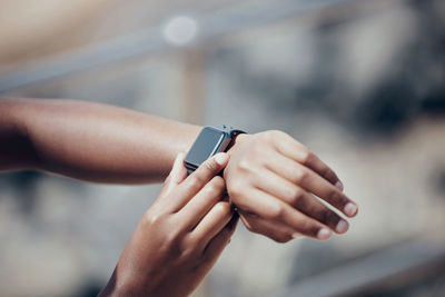 Cropped hand of man using mobile phone