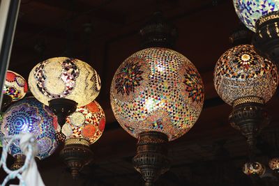 Low angle view of illuminated lanterns hanging at market stall