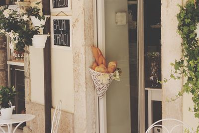 Food in basket on wall outside house