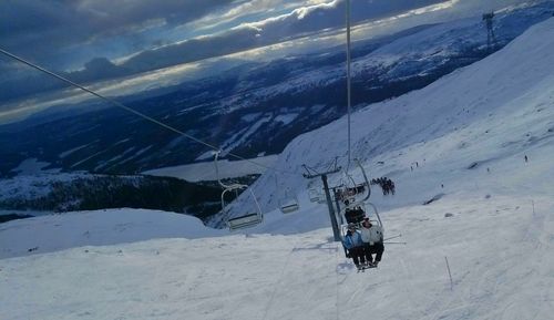 Ski lift on snow covered mountain