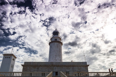 Low angle view of lighthouse against cloudy sky