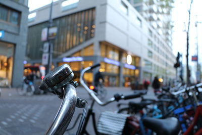 Bicycle on street against buildings in city
