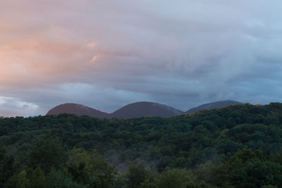 Scenic view of mountains against cloudy sky