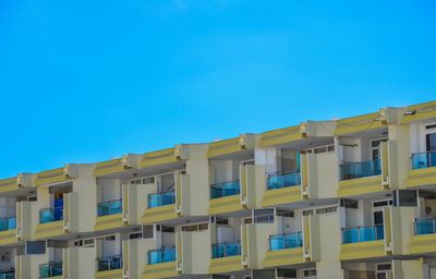 Low angle view of residential building against blue sky