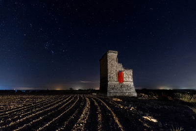 Scenic view of field against sky at night