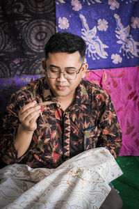 Man with textile working in workshop