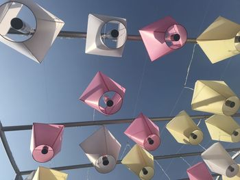 Low angle view of lighting equipment hanging against clear sky