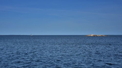 Scenic view of sea against blue sky