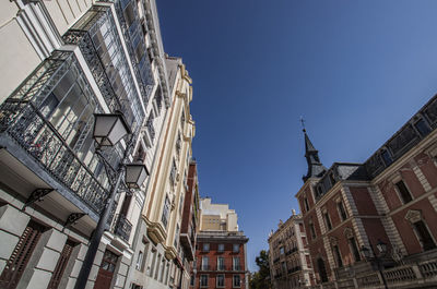 Low angle view of buildings against blue sky