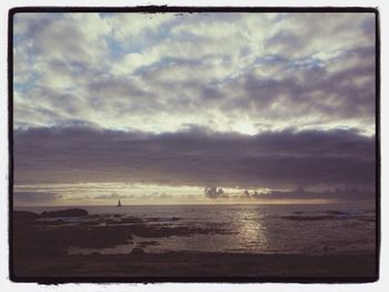 Scenic view of sea against cloudy sky