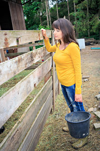 Side view of woman standing by plants