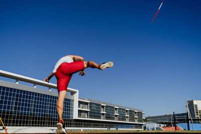 Full length of woman against blue sky