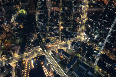 High angle view of city lit up at night